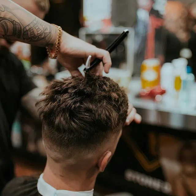 Barbero perfilando un corte con tijera